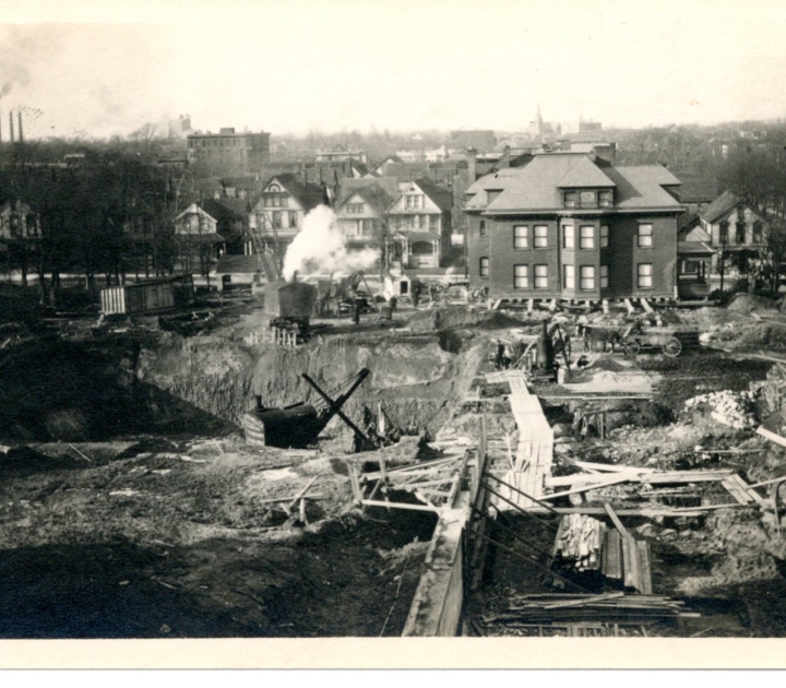 Principal's residence still on timbers after having been moved from its former location in immediate foreground of picutre. Spring 1913.