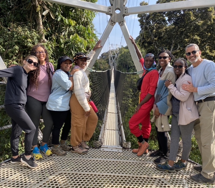 Rwandan visitors a pose on a bridge