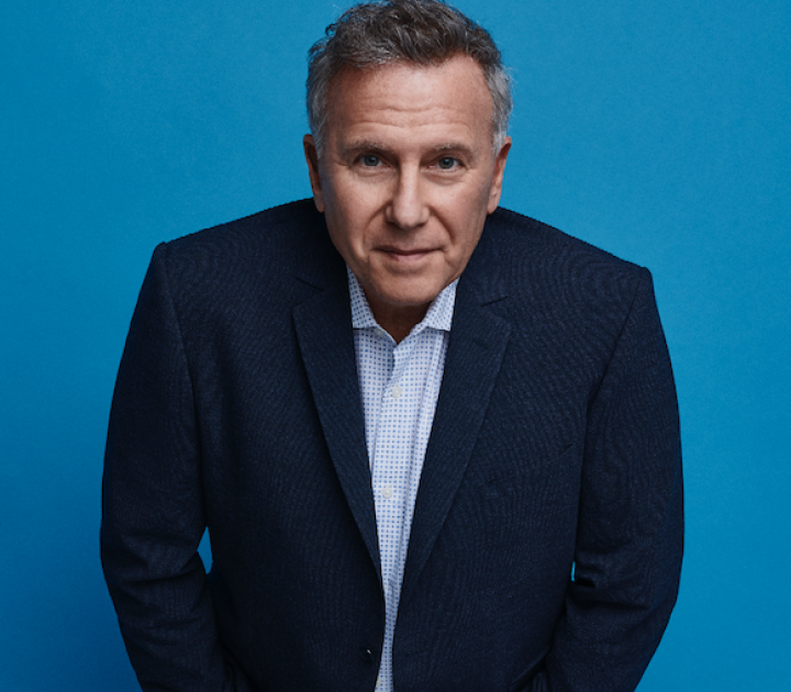 Paul Reiser standing with hands in pockets