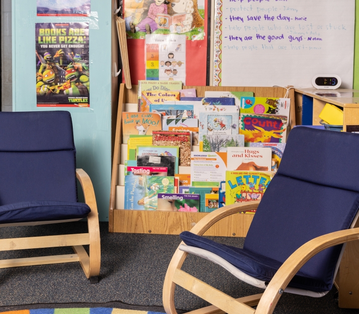 Child Care Center room with books, posters, and rocking chairs
