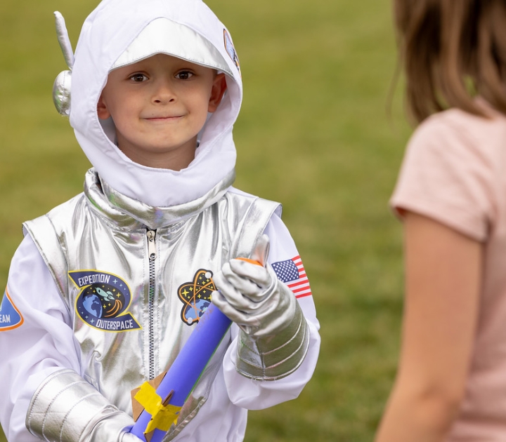 Smiling child wearing astronaut costume