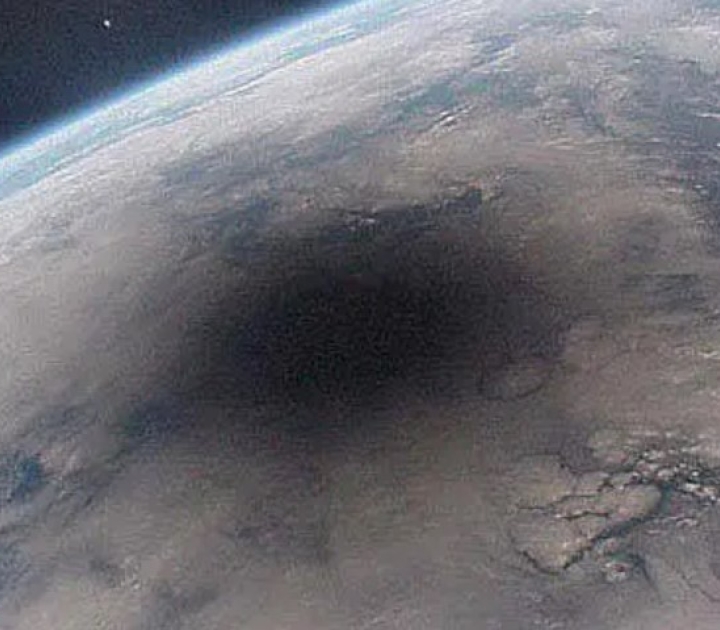 During a solar eclipse, the moon casting a large shadow onto Earth's surface.