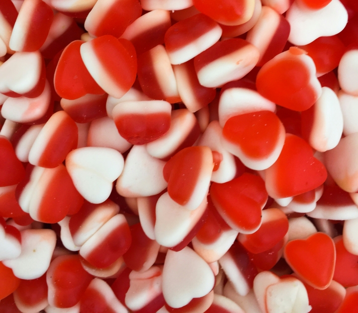 A collection of gummy red candy hearts