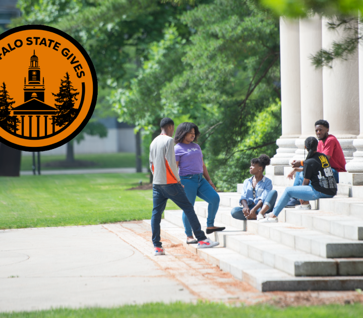 Students sitting on steps of Rockwell Hall with Buffalo State Gives logo displayed