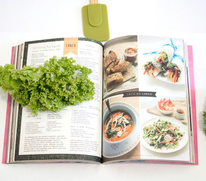 Cookbook with herbs and spatula