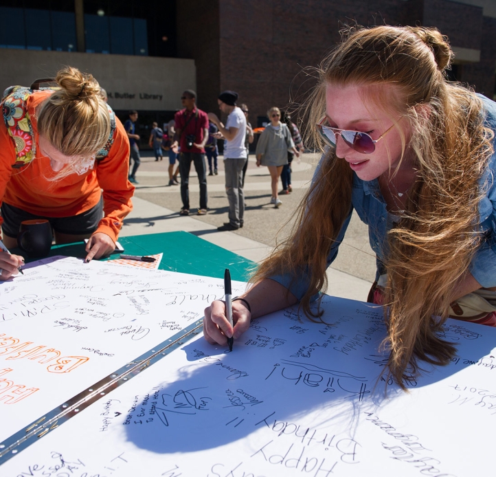 Students writing on a poster