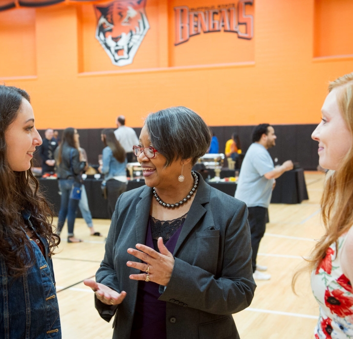 Two students with President Conway-Turner at Senior Celebration