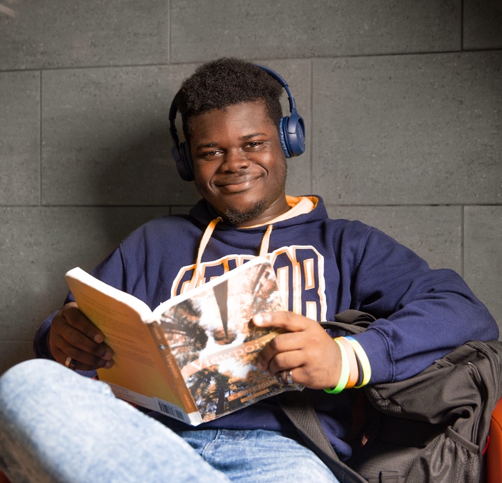 Smiling student reading a book