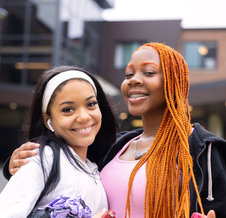 Two students smiling outside