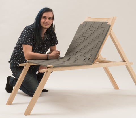 Student posing with his chair
