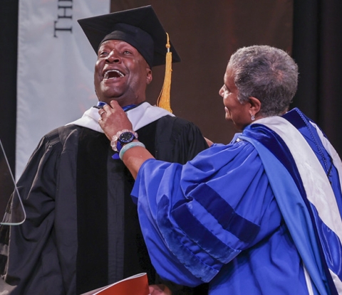Grandmaster Flash smiling broadly as he receives honorory doctorate