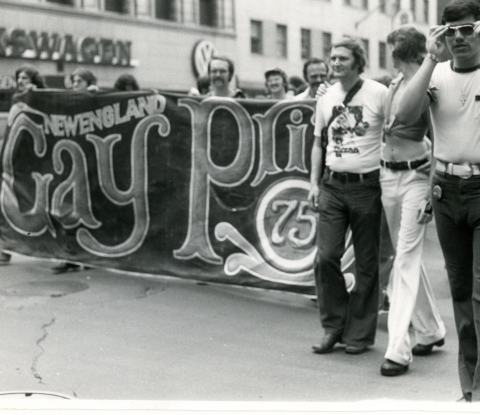 Pride march in NYC 1975. Marchers display banner that reads, "New England Gay Pride 75."