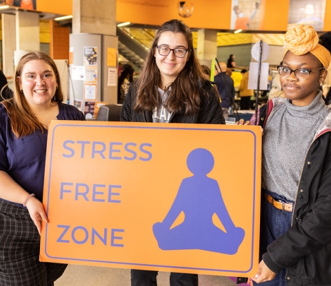 Three students hold a sign that says "Stree Free Zone" at the Fresh Check Event