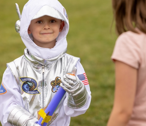 Smiling child wearing astronaut costume