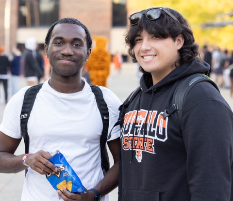 Two students in the Plaza during Homecoming weekend
