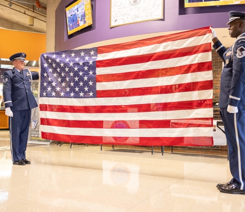 Two servicemen display the US flag