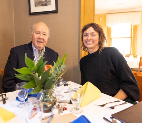 G. Peter Jemison seated at a table with a guest at the luncheon honoring his work