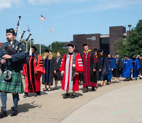 Academic convocation marchers and bagpiper