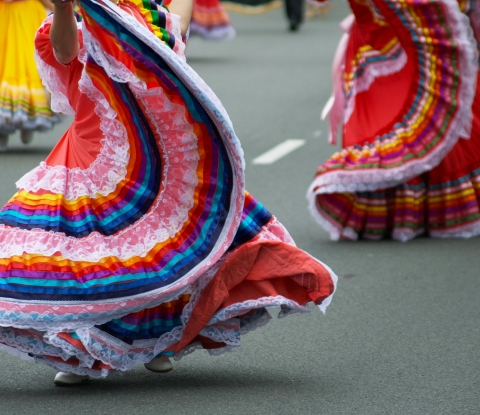 Women dancing in the street with colorful skirts