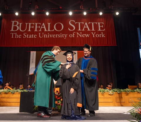 Student is presented by 2 professors at commencement