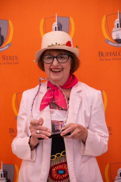 Barbara Blackburn, smiling, holding her award