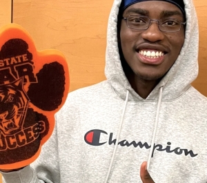 Student holding a foam finger