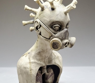 Clay scupture of head in gas mask