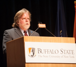 Professor David Carson speaking at a Buffalo State lectern