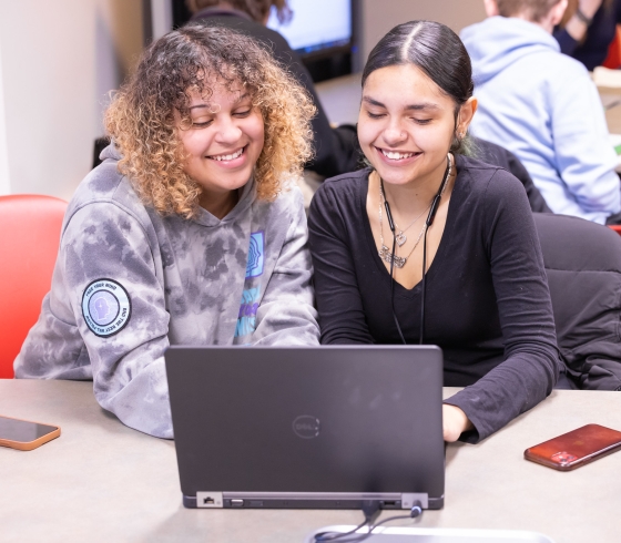Two female students sharing a computer