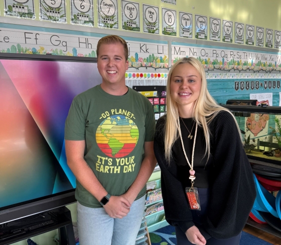 Alex and Madison standing in a classroom