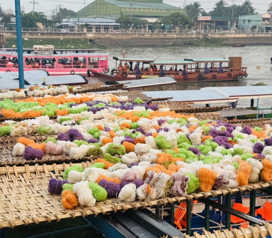 Colorful noodles drying at a floating market on the Can River in the Mekong Delta