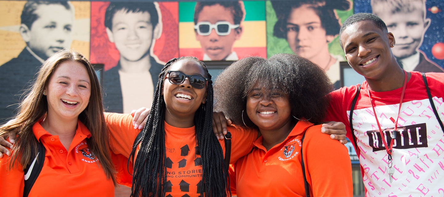 Students in front of a mural on Elmwood Avenue