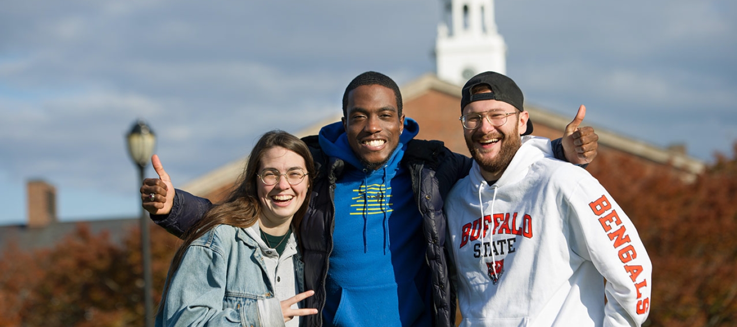 Three students in front of Rockwell Hall
