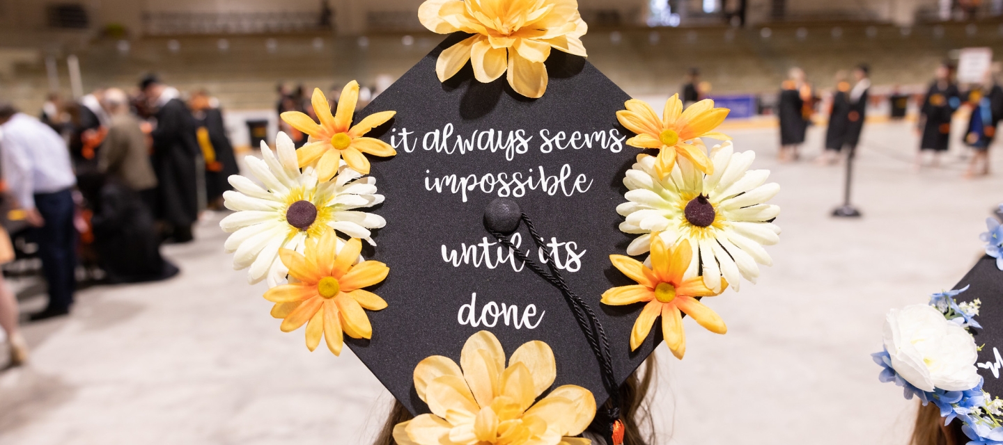 Graduation cap that reads "It always seems impossible until it is done"