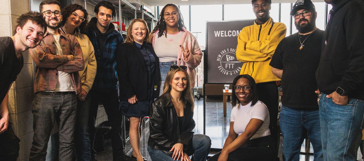 A group of students standing in front of a sign that reads Welcome to New Era Buffalo State Design a Thon