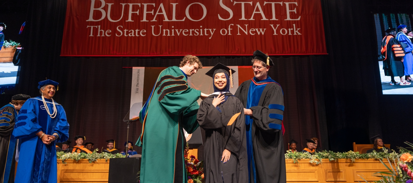 Student is presented by 2 professors at commencement