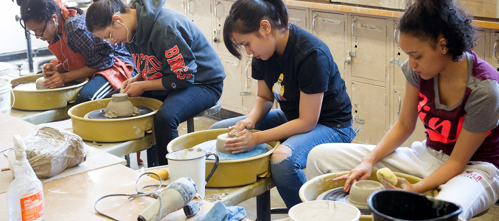 Students at potter's wheels