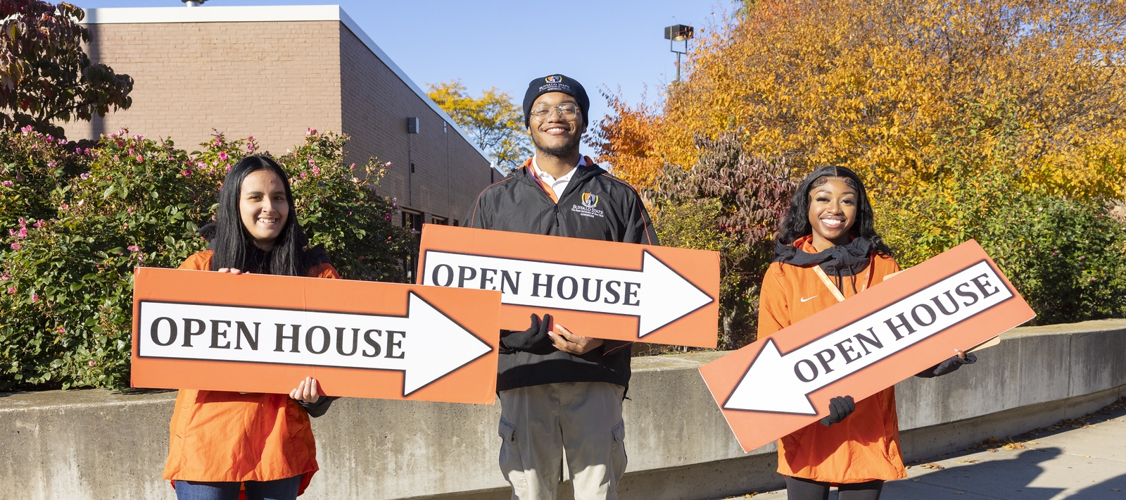 Students holding Open House signs