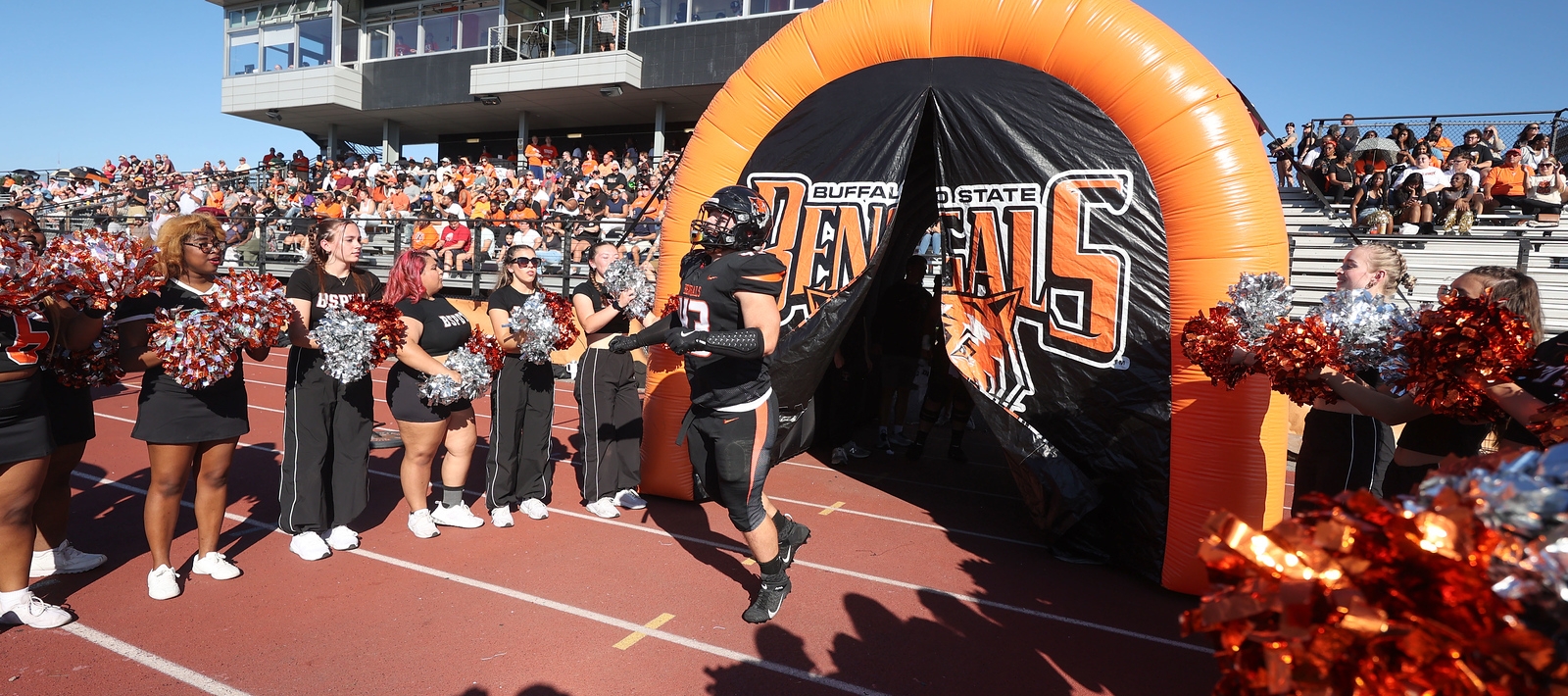 Player busting through a Bengal arch.