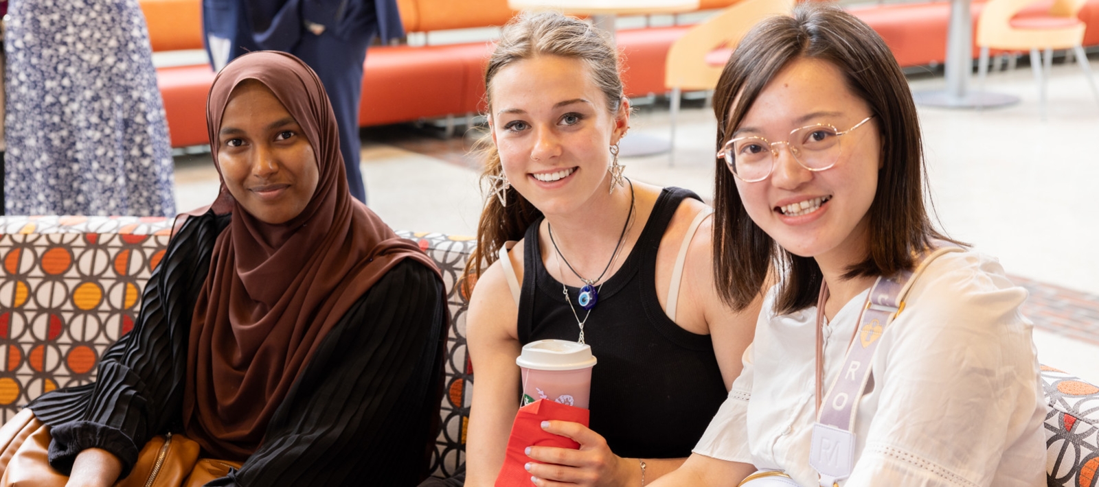 Students smiling and drinking coffee