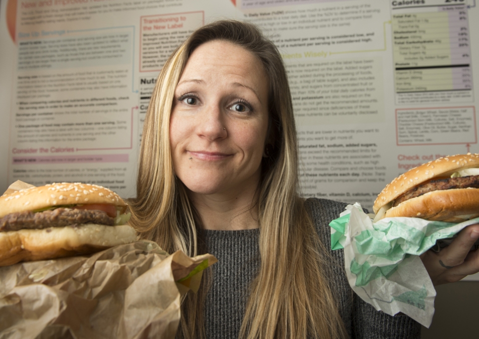 Liz Hartz holding two burgers