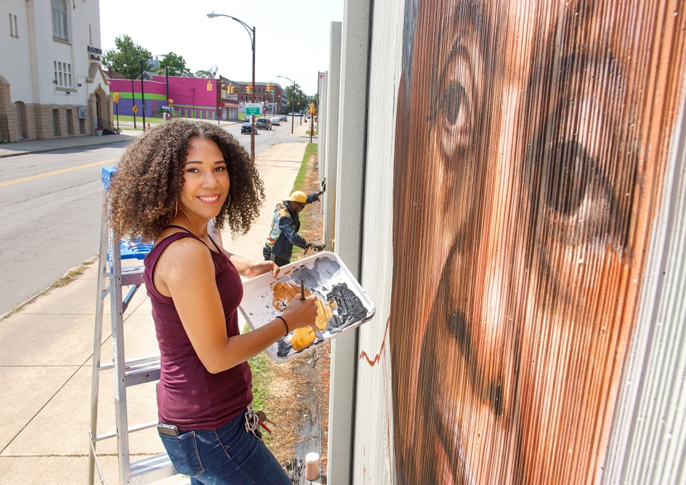 Julia Bottoms-Douglas painting a city mural