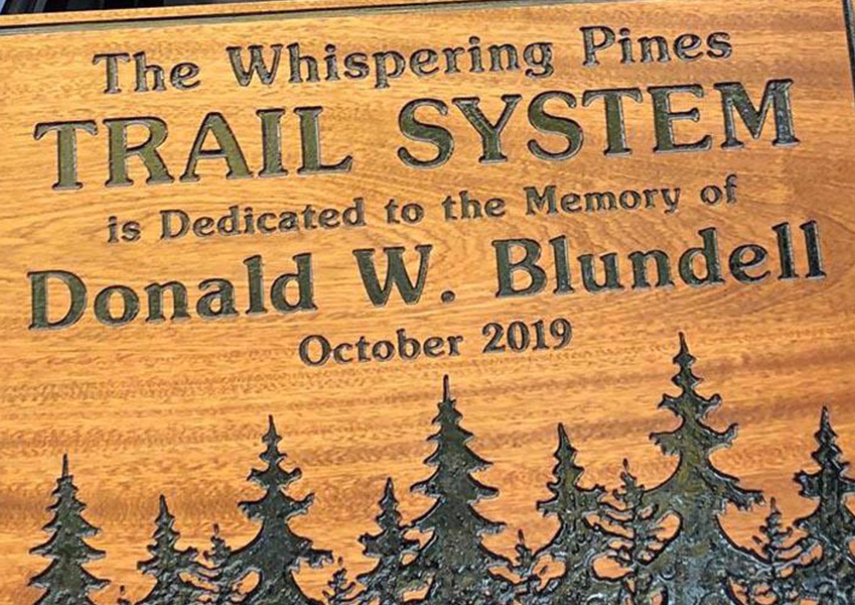 Trail System plaque dedicated to Don Blundell