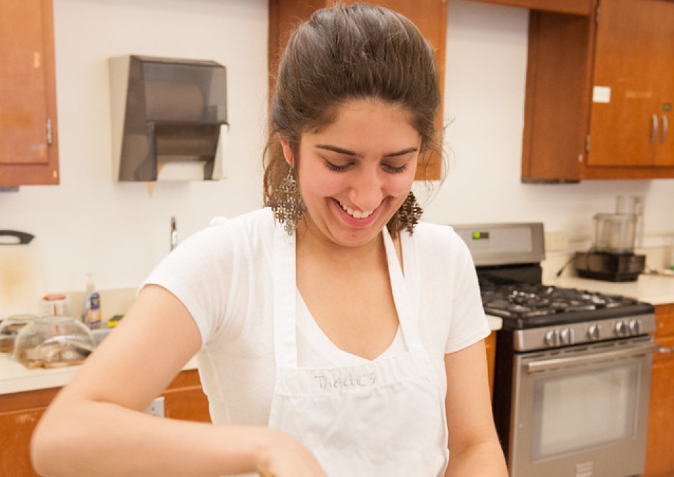 Female dietetics student stirring a pot on the stove