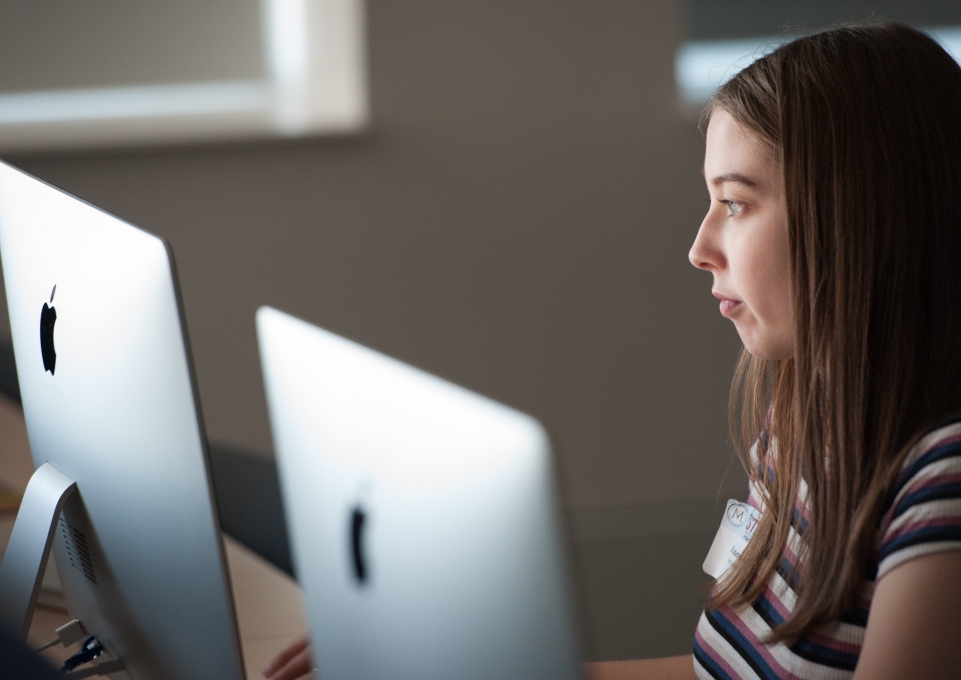 Teenage girl looking at computer screen
