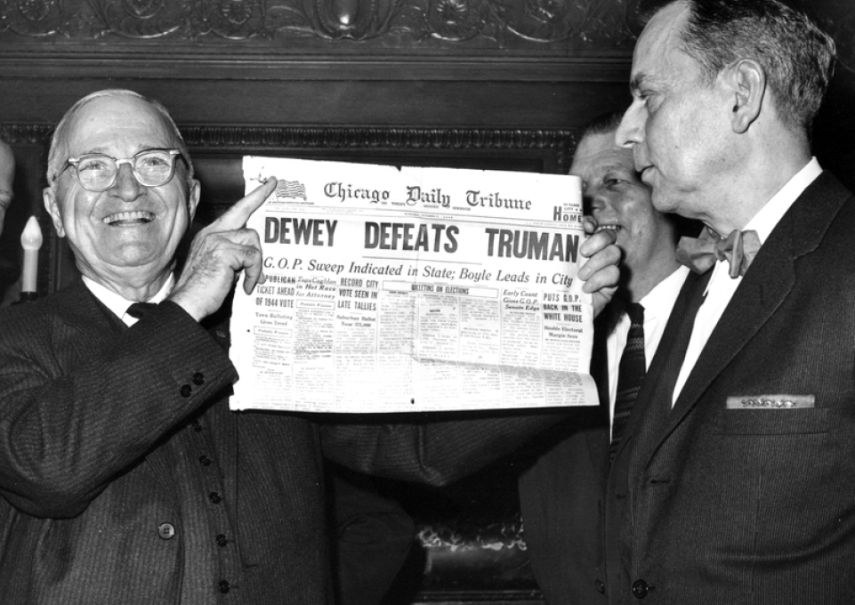A smiling former President Harry S. Truman (left) holds a copy of the famous Chicago Daily Tribune paper declaring "Dewey Defeats Truman."