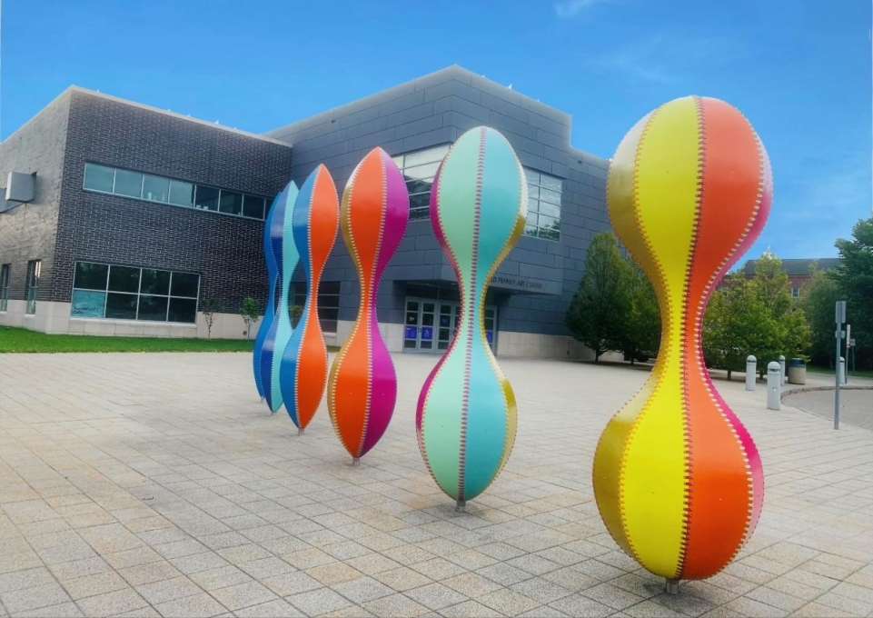 New sculpture outside the Burchfield Penney: Six hourglass-shaped multicolored upright figures