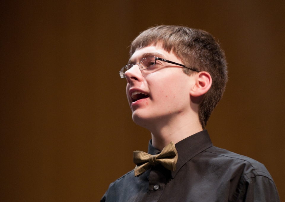 Young singer in a bow tie and black shirt