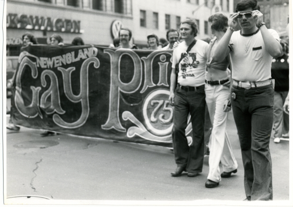 Pride march in NYC 1975. Marchers display banner that reads, "New England Gay Pride 75."