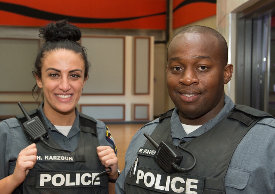 UPD officers Hadeel Karzoun and Maxwell Ravenell III facing the camera and smiling